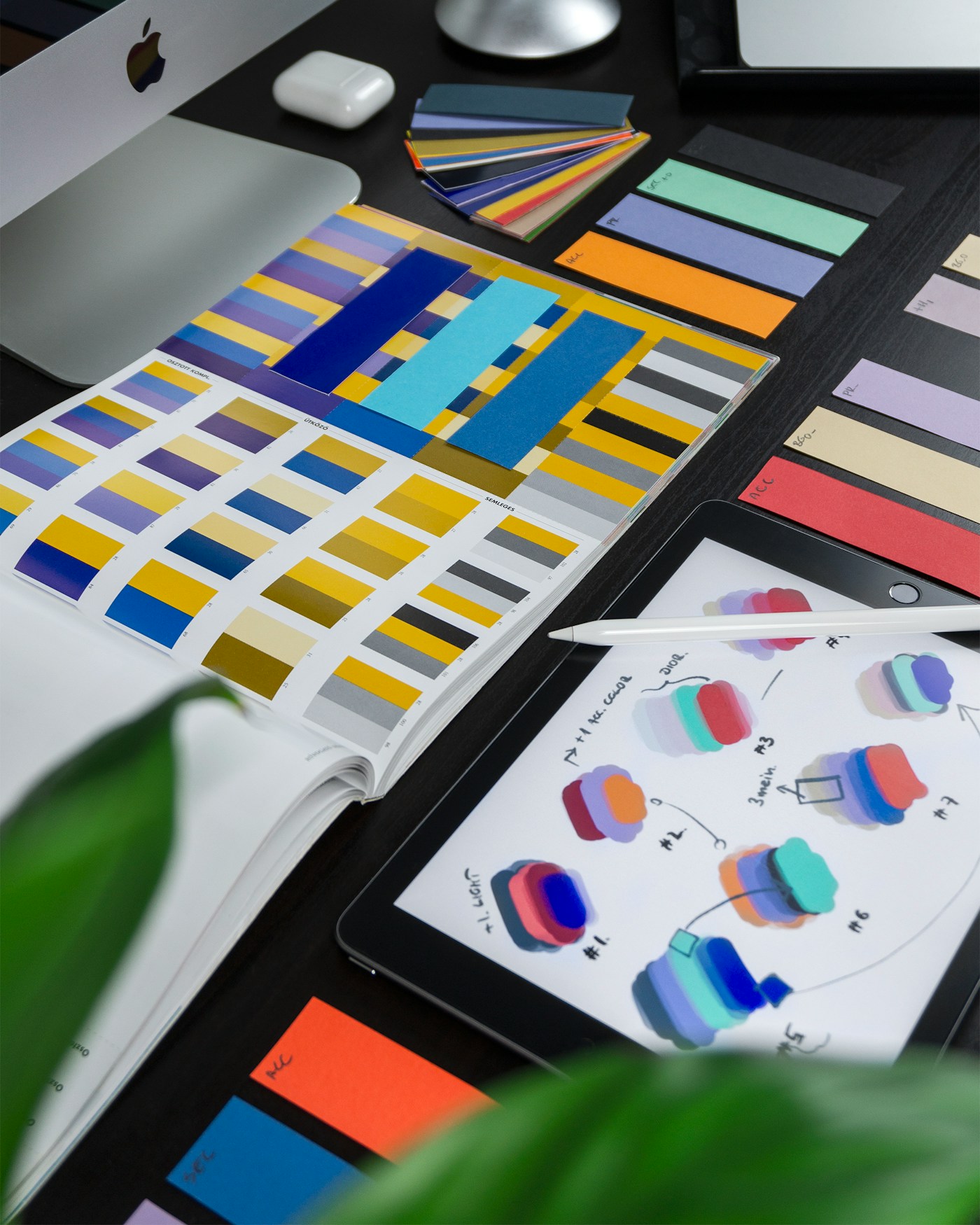 Brand identity workspace with color swatches, sketches, and design materials