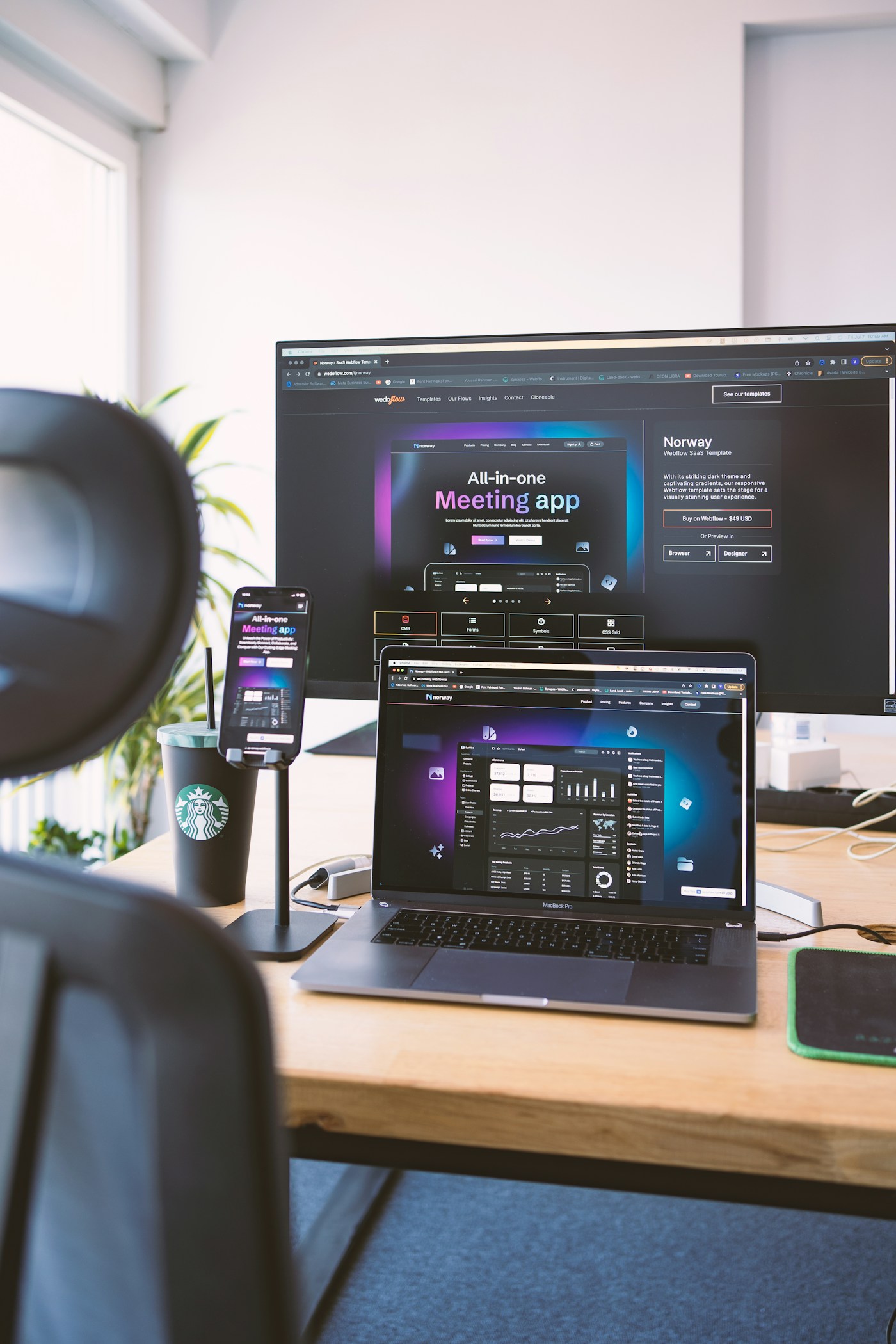 Responsive website design workspace with a laptop, monitor, and mobile screen